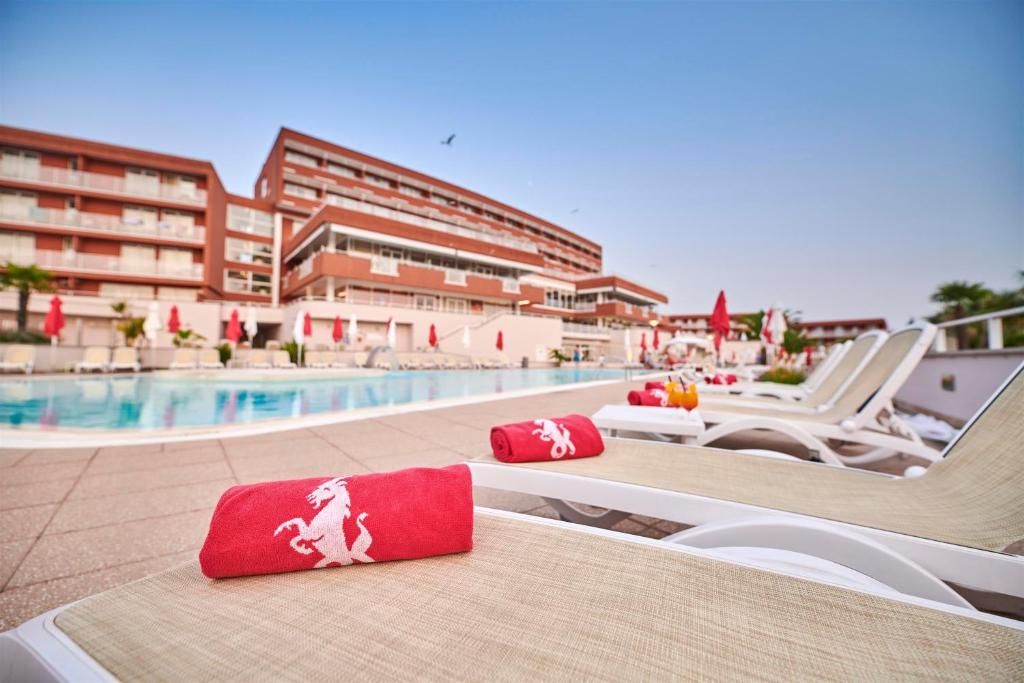 a resort with a swimming pool and some lounge chairs at Hotel Albatros Plava Laguna in Poreč