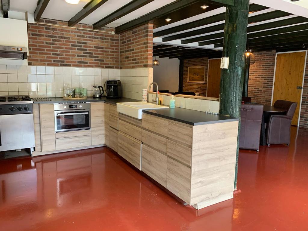 a large kitchen with a counter top in a room at Familiehuis in Diever