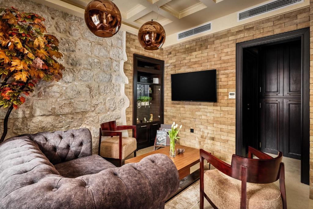 a living room with a couch and a table at Apartment Lav in the City Centre in Kotor