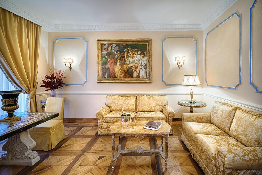 a living room with a couch and a table at Frezza Apartment - Alta Luxury Apartments in Rome