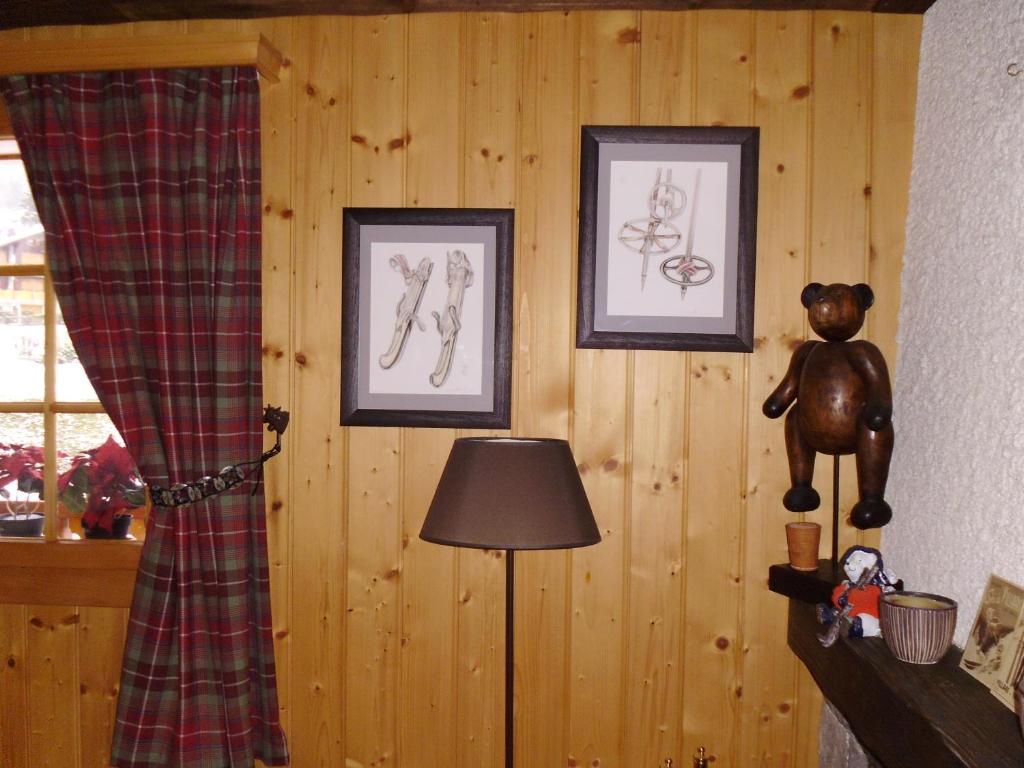 a room with two pictures and a teddy bear on the wall at Petit Ours in Villars-sur-Ollon
