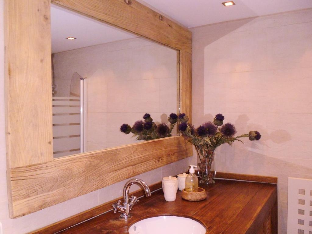 a bathroom with a sink and a large mirror at Petit Ours in Villars-sur-Ollon