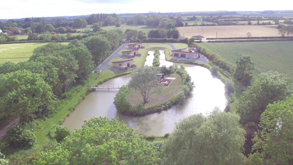 an aerial view of a river with houses and trees at col's mere in Upton