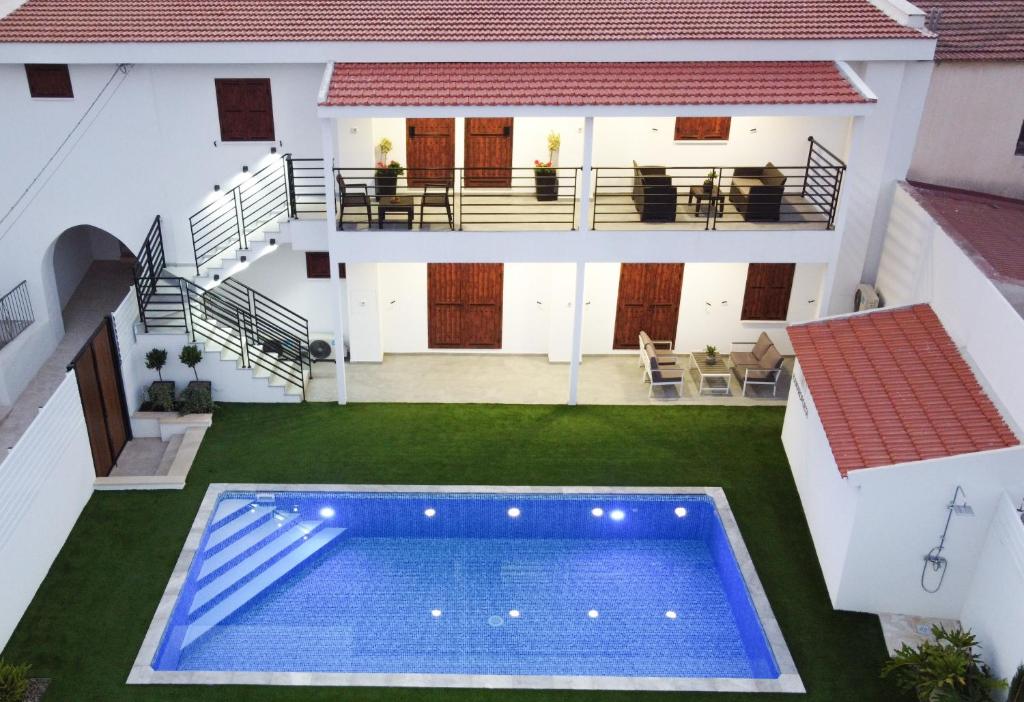 an aerial view of a house with a swimming pool at Kamaroporta Luxury Apartments in Ayios Theodhoros