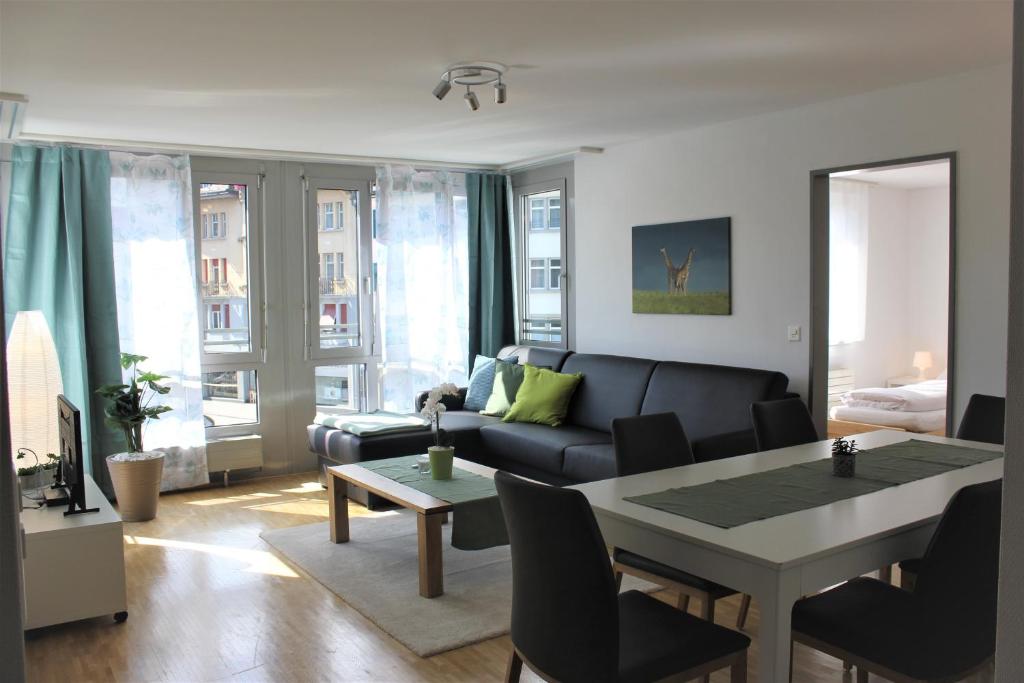 a living room with a couch and a table at Herisau Apartments in Herisau