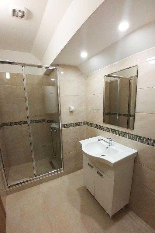 a bathroom with a sink and a shower at Zeleno srce in Soko Banja