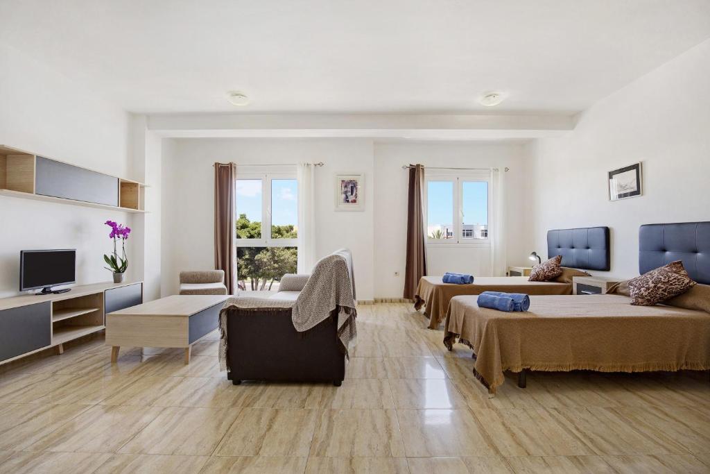 a large living room with two beds and a couch at Apartamento Betty B in Puerto del Rosario