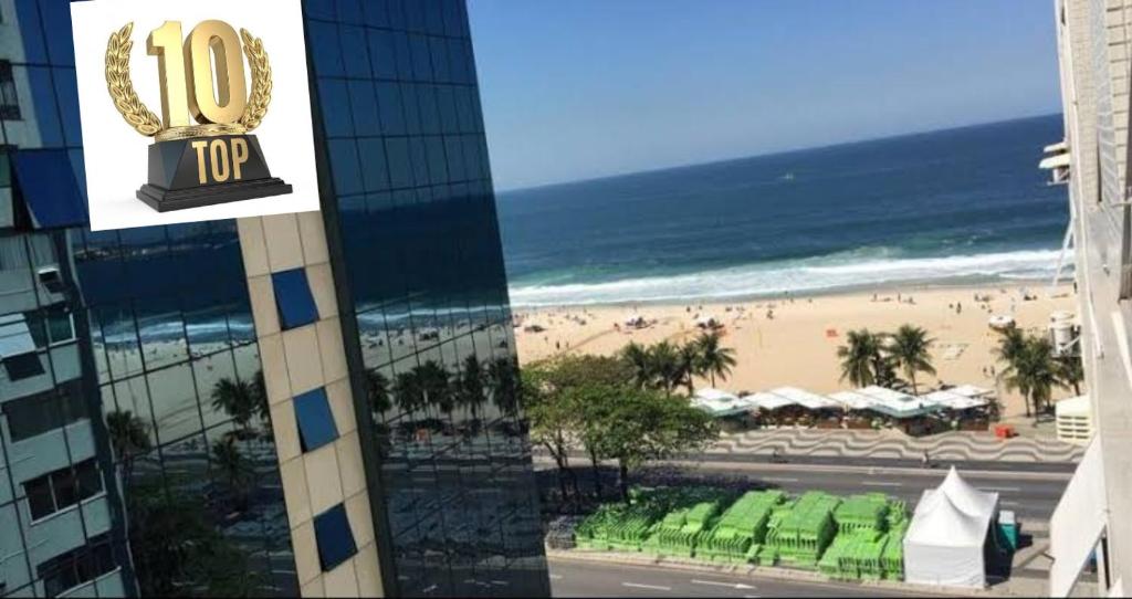 a view of a beach from a hotel window at Copacabana Beach Modern Apartments in Rio de Janeiro