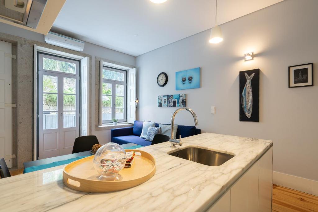 a kitchen with a sink and a counter top at OPO Downtown Blue in Porto