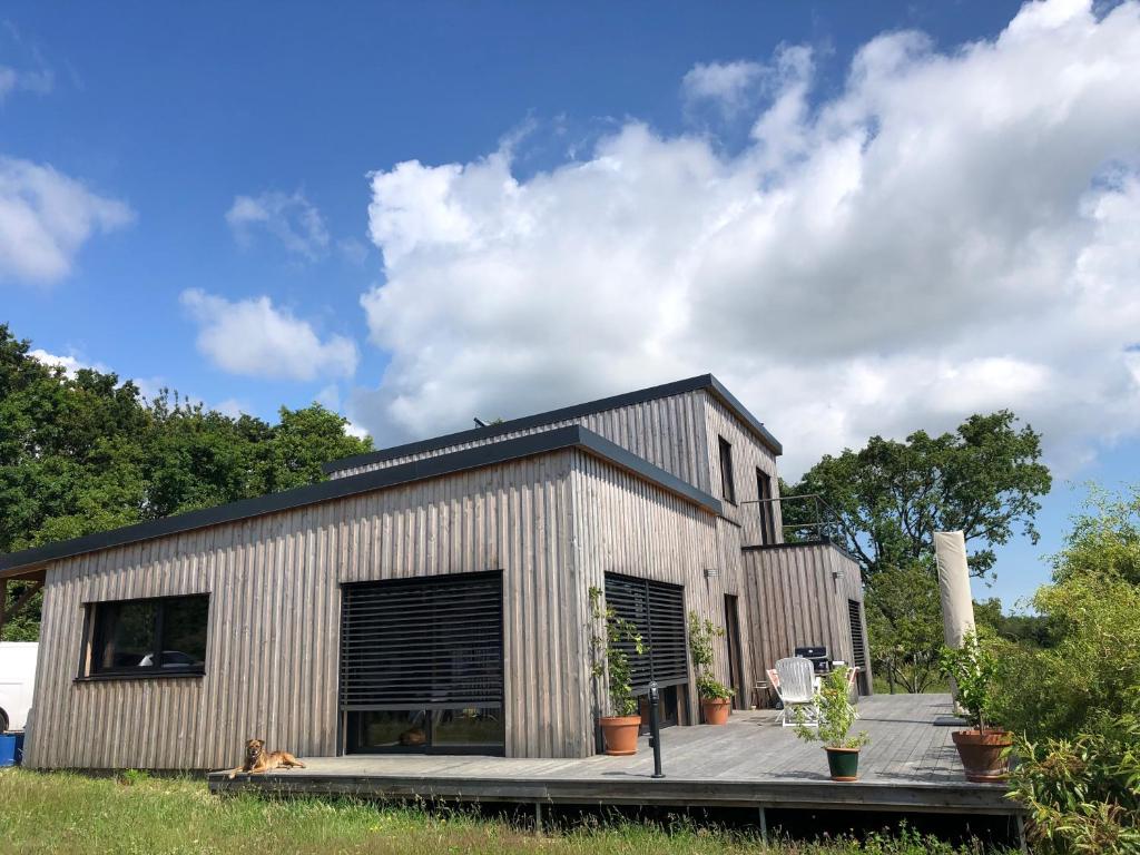 a metal building with a black roof at Maison entre Golfe du Morbihan et Presqu'île de Rhuys in Surzur