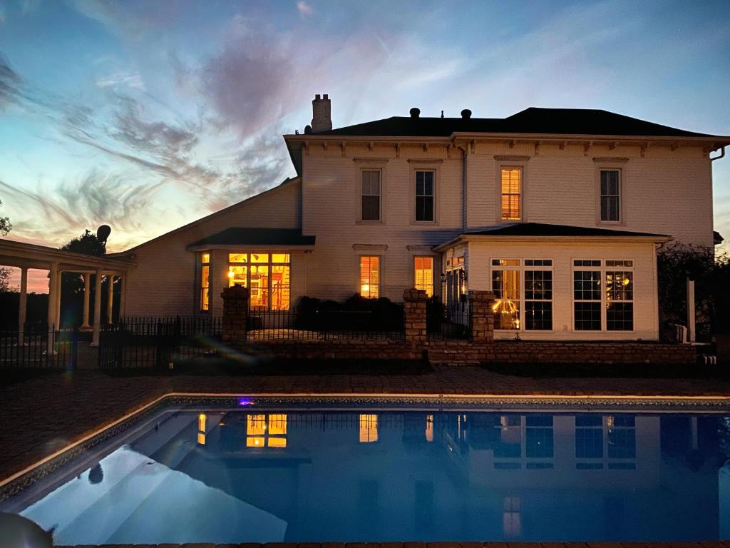 a house with a swimming pool in front of it at Wildflower Ranch Inn in Springfield