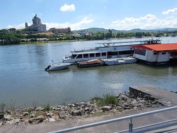 a large boat docked at a dock on a river at Ferienbungalow Tinka in Štúrovo