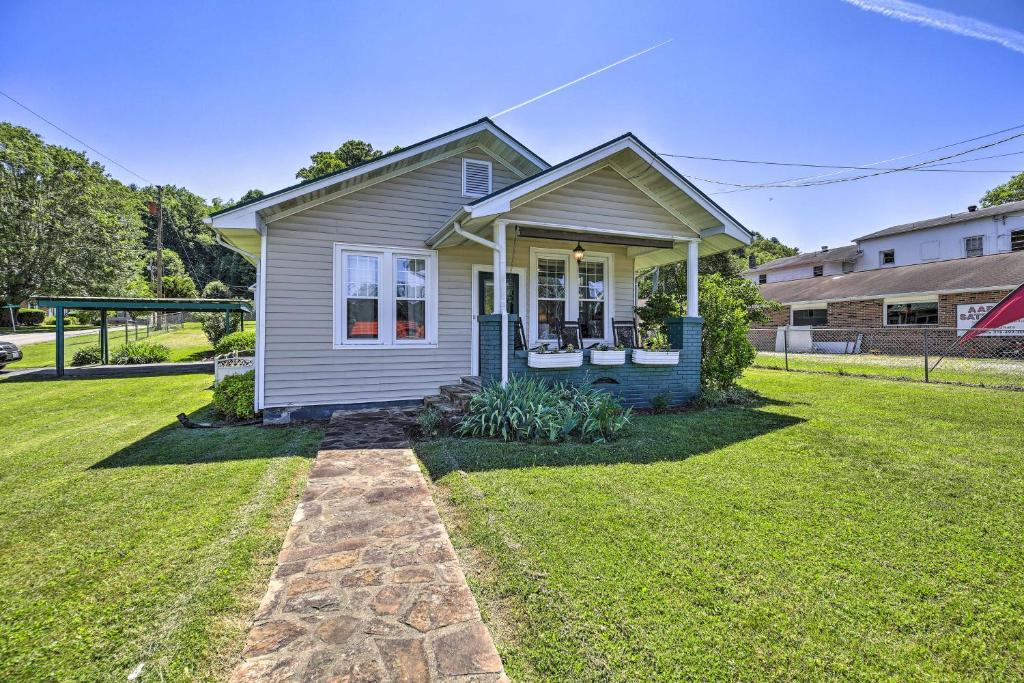 a small house in a yard with a green lawn at Cozy Damascus Cottage with Porch and Trail Access! in Damascus