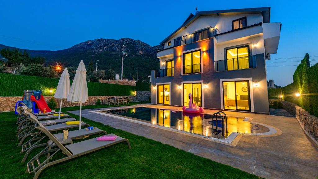 a house with a swimming pool in the yard at Atlantis - 4 Bedroom Holiday Villa in Hisaronu in Oludeniz