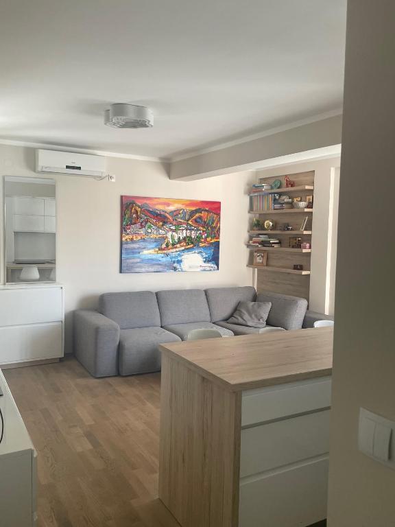 a living room with a couch and a table at Apartment AndjelaS in Tivat