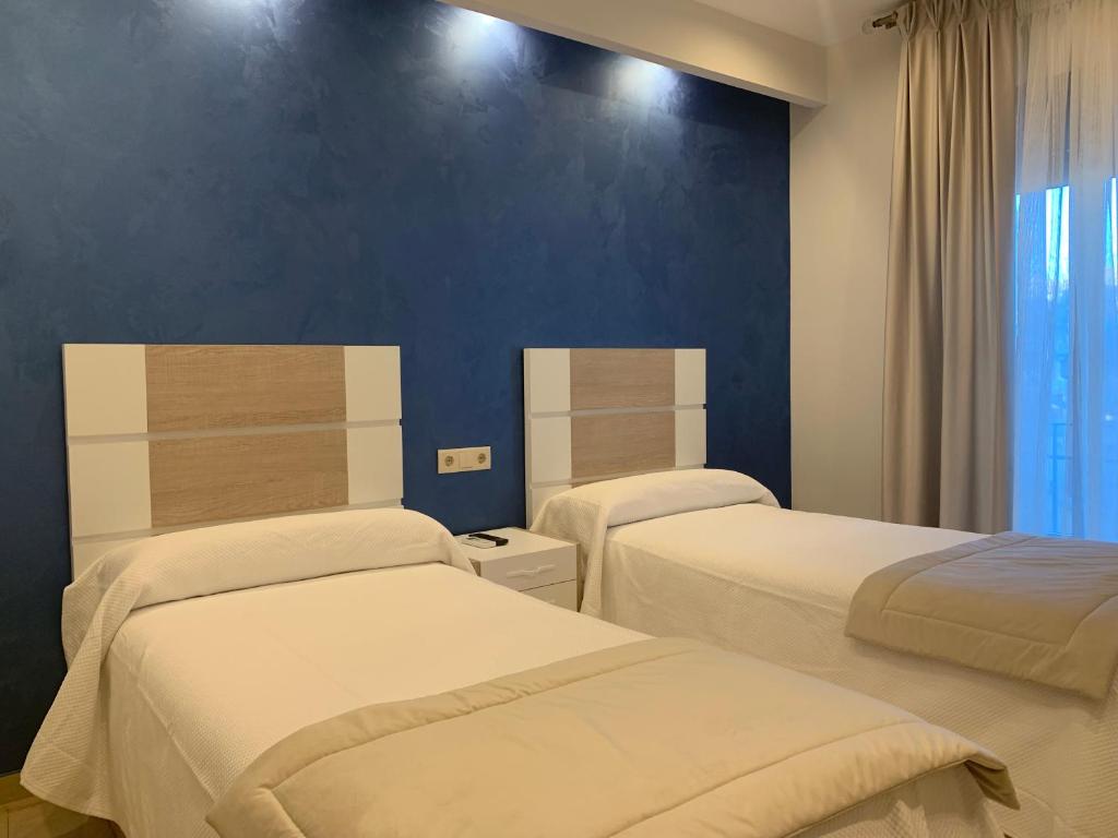 Postel nebo postele na pokoji v ubytování Hostal Poeta Machado