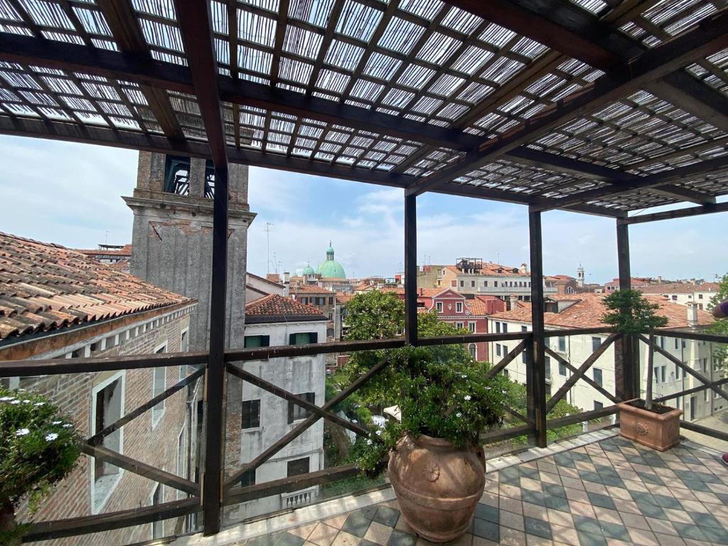 a view of a city from a balcony with a plant at Ai Due Fanali Adults Only in Venice