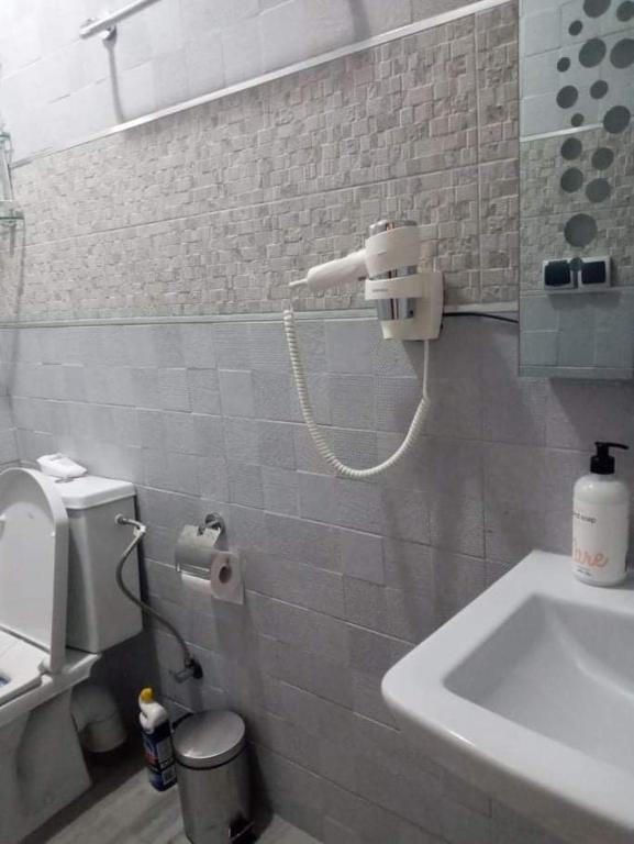 a bathroom with a toilet and a sink in it at Al-marsa2 in Al Hoceïma