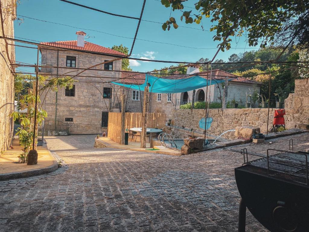 a building with a blue tent in the middle of a street at Casa do Convento in Arcos de Valdevez