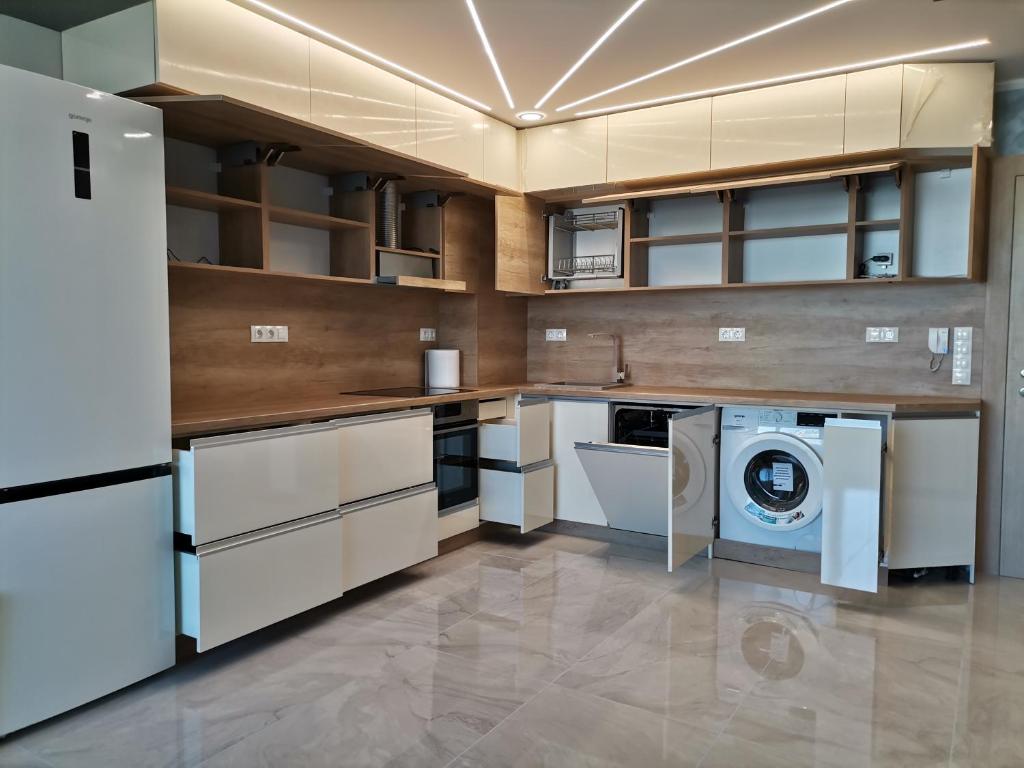 a kitchen with a washer and dryer in it at Апартамент на няколко минути от Летището in Sofia