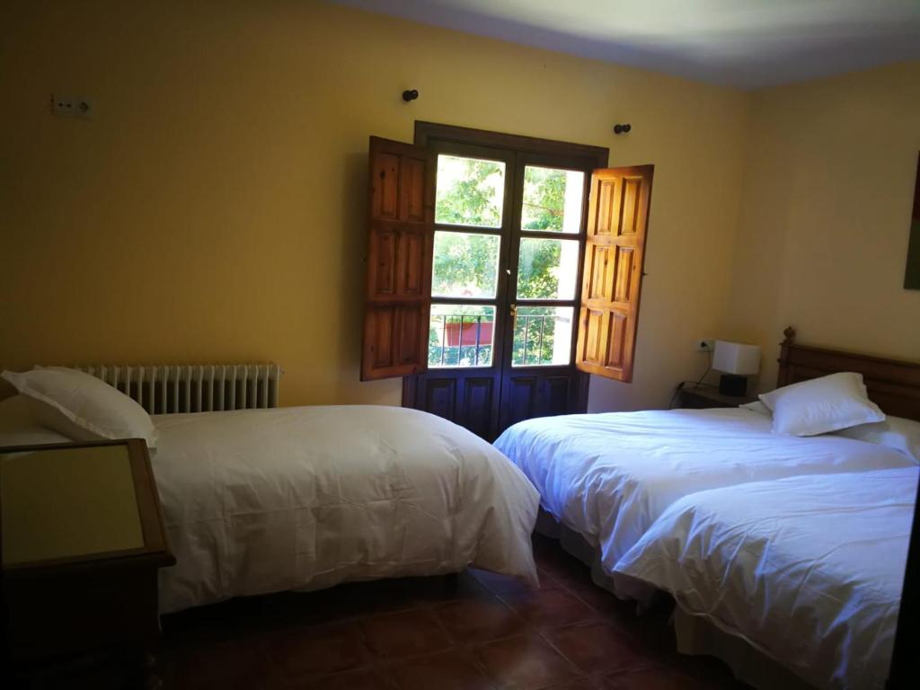 
A bed or beds in a room at El Jardin del Conde
