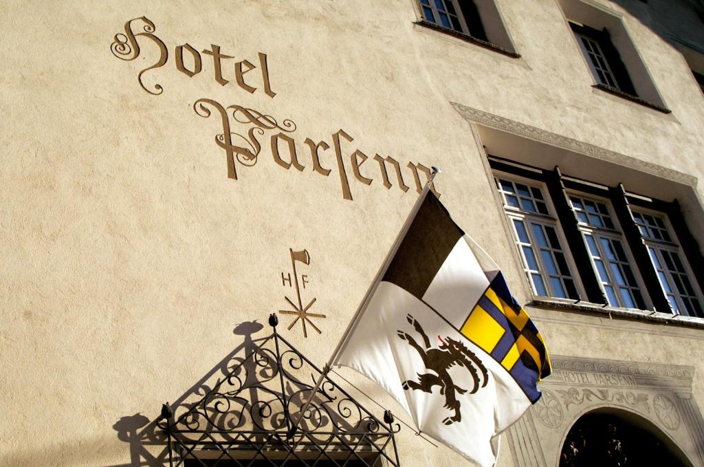 a building with a sign on the front of it at Hotel Parsenn in Davos