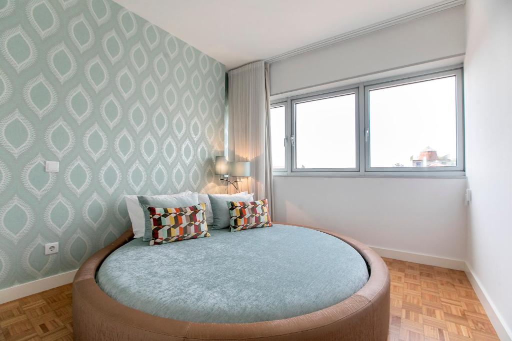 Postel nebo postele na pokoji v ubytování Casa D'Ouro Apartment