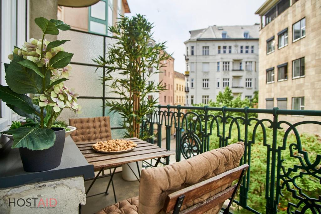 a balcony with a table and chairs on a balcony at M52 Apartment - hostAID in Budapest