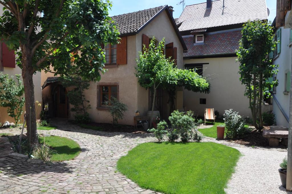 a courtyard of a house with a garden at Au Grès des Vignes in Turckheim
