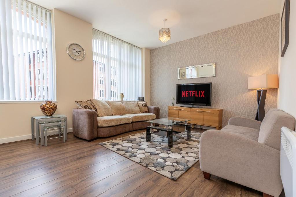 a living room with a couch and a fireplace at Oakstays Central Gem in Newcastle upon Tyne