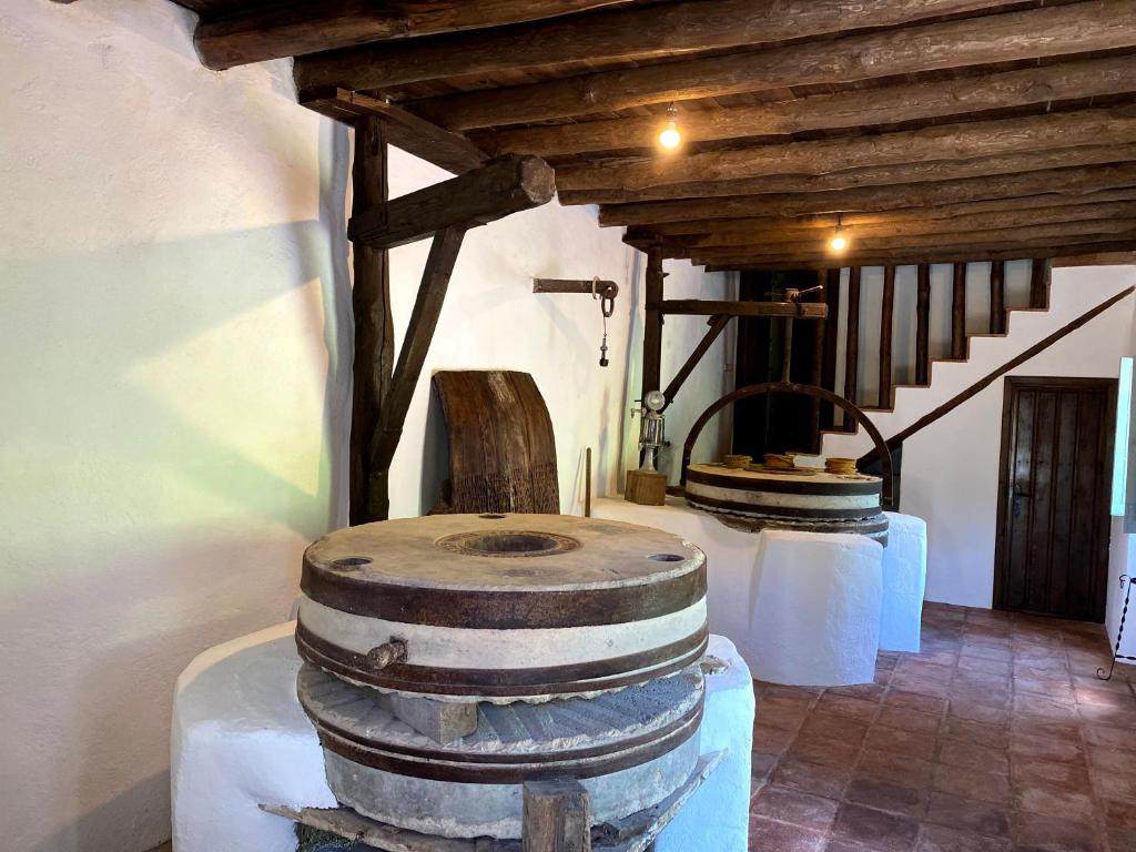 una habitación con 2 barriles de vino y una escalera en Casa Rural Molino de Bony, en Júzcar