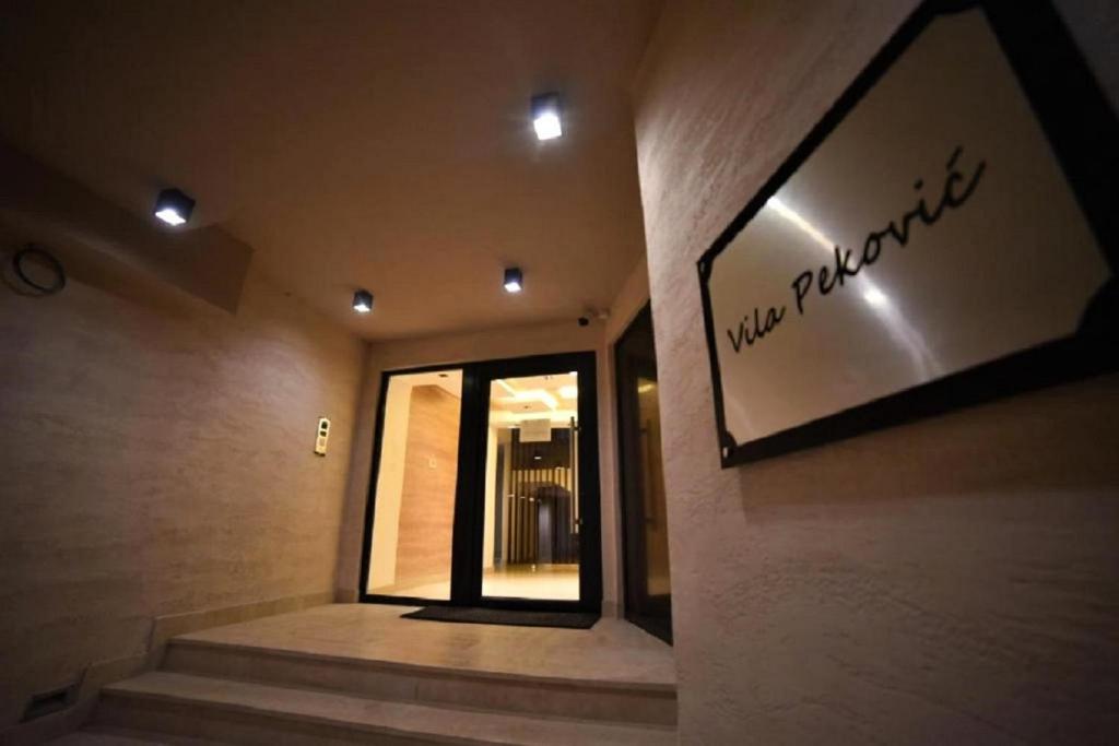 a sign on the side of a building with a window at Apartman Green Lux - Balkan Hil 1 in Zlatibor