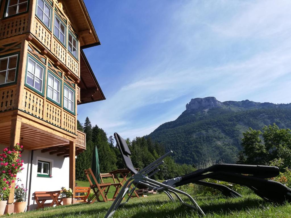 a bicycle in the grass in front of a building at Haus Horvath Bett und Brot in Altaussee