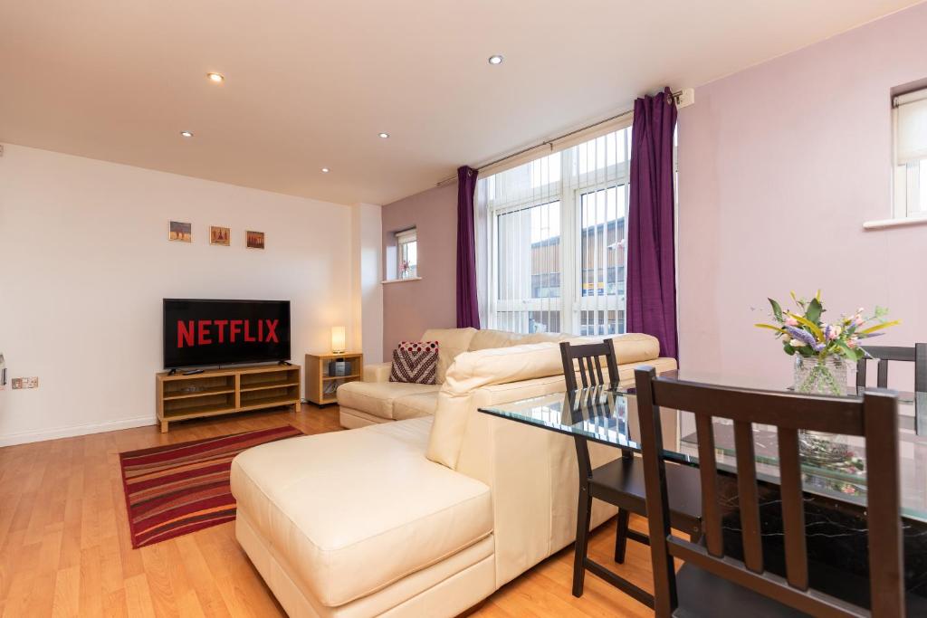 a living room with a couch and a table at Oakstays Stylish Quayside Gem in Gateshead