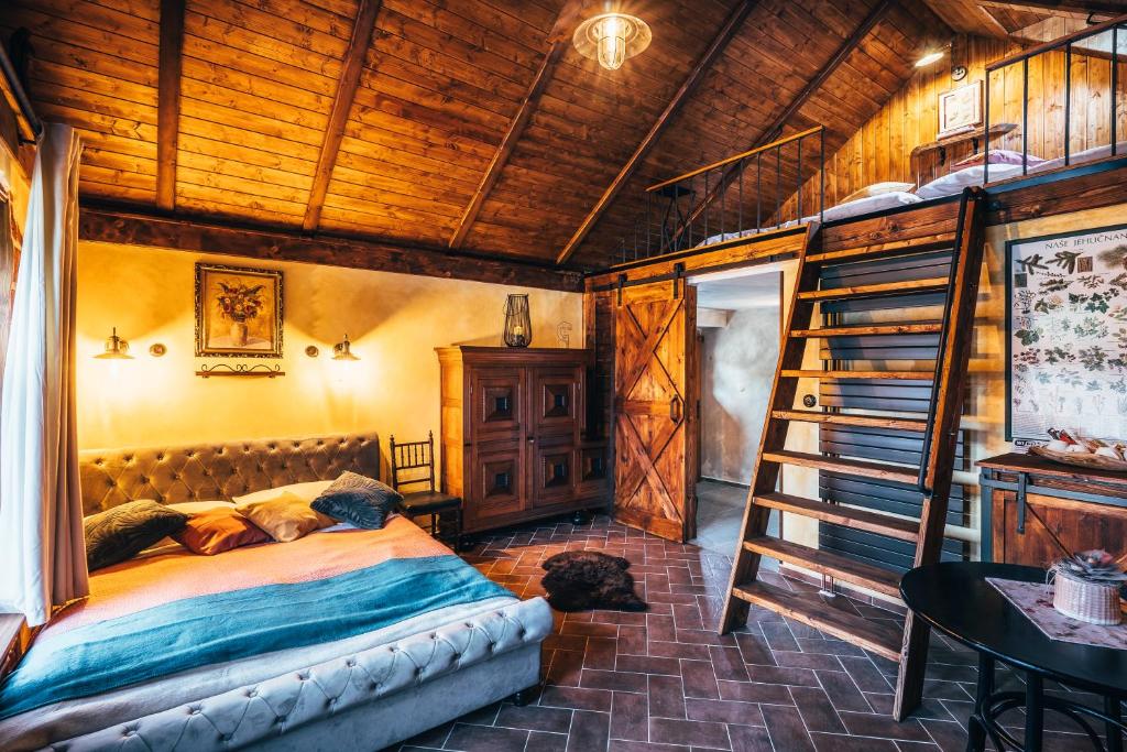 a bedroom with a bed and a wooden ceiling at Pension Fialka in Český Krumlov