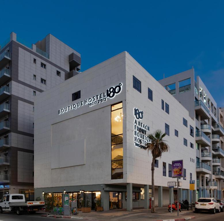 a large white building with a sign on it at 180 Boutique Hostel in Tel Aviv