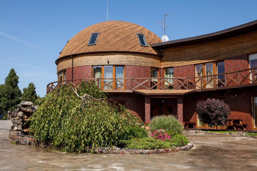 a large brick building with a roof at Vila Sraige in Palanga