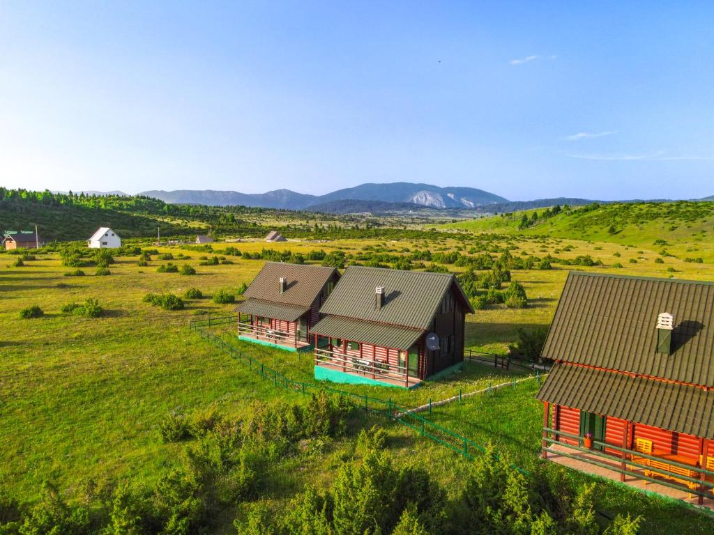 an aerial view of two barns in a field at Family lux Apartments in Žabljak