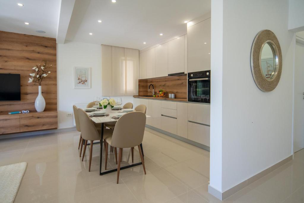 a kitchen and dining room with a table and chairs at Luxury Garden apartment in Pakoštane