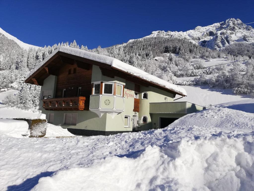 a chalet in the snow in the mountains at Haus Spiss in Flirsch