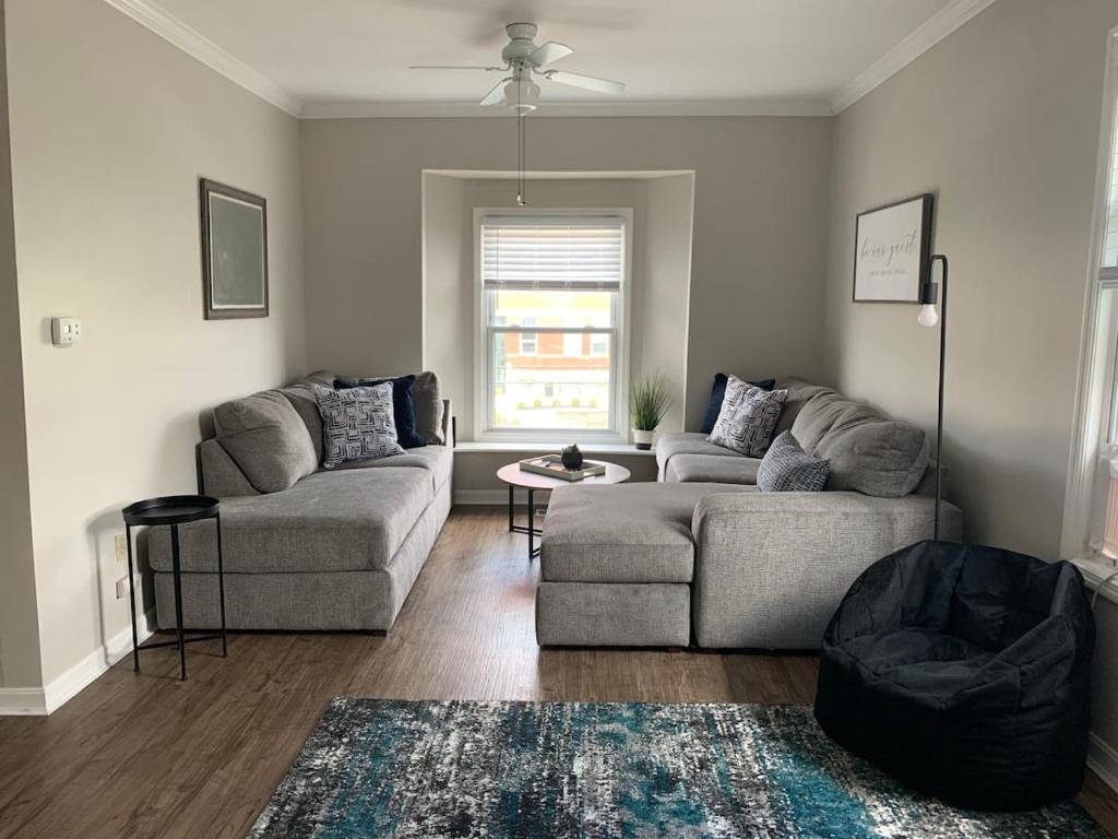 a living room with two couches and a table at Hyde Park Getaway - Close to Square & Downtown! in Cincinnati