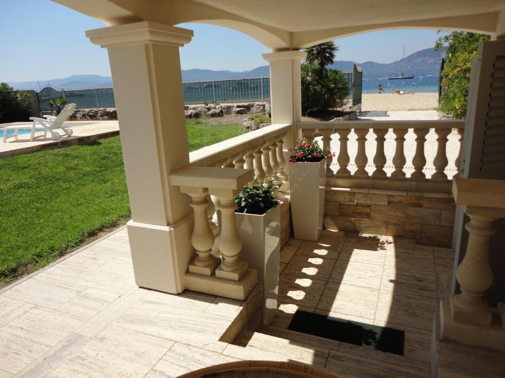 a porch with two potted plants and a view of the beach at Villa Playa del Sol -B4 in Saint-Tropez