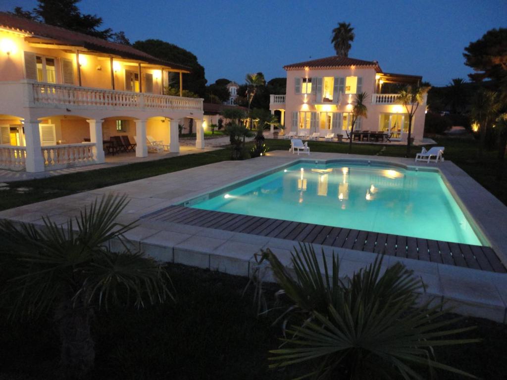 a swimming pool in front of a house at night at Villa Playa del Sol -B4 in Saint-Tropez
