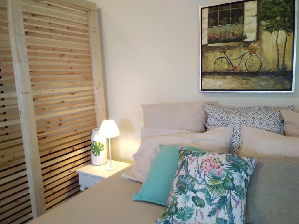 a bedroom with a bed and a picture of a bike at blue cielo sunny apartment in Palaiá Fókaia