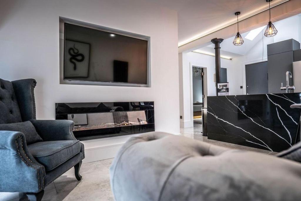 a living room with a couch and a large mirror at Luxury royal mile boutique 2bedroom apartment in Edinburgh