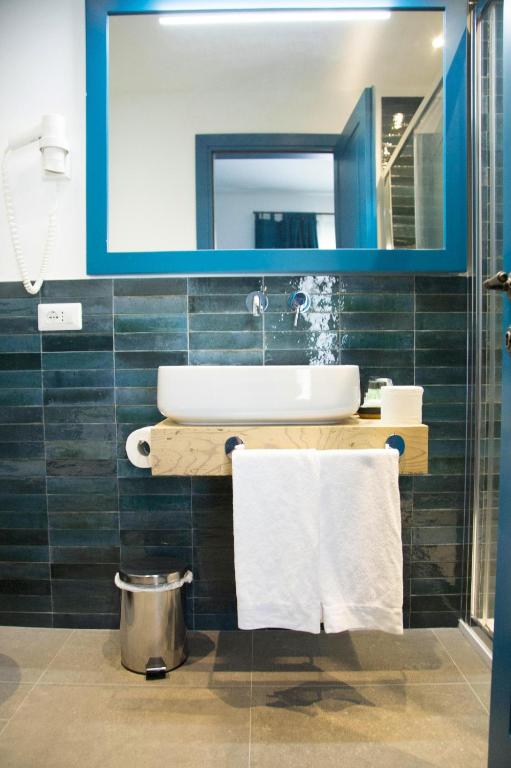 a bathroom with a sink and a mirror at Isolotto Guest House in Porto Ercole