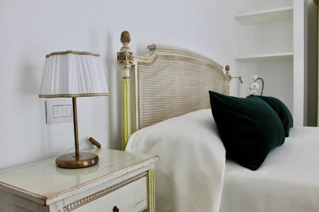 a bedroom with a bed and a table with a lamp at Cetara Costa d'Amalfi Residence in Cetara
