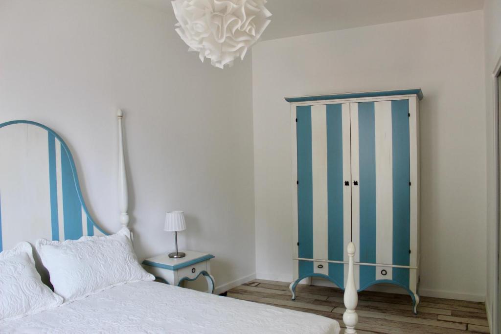 a bedroom with a bed and a blue cabinet at Cetara Costa d'Amalfi Residence in Cetara