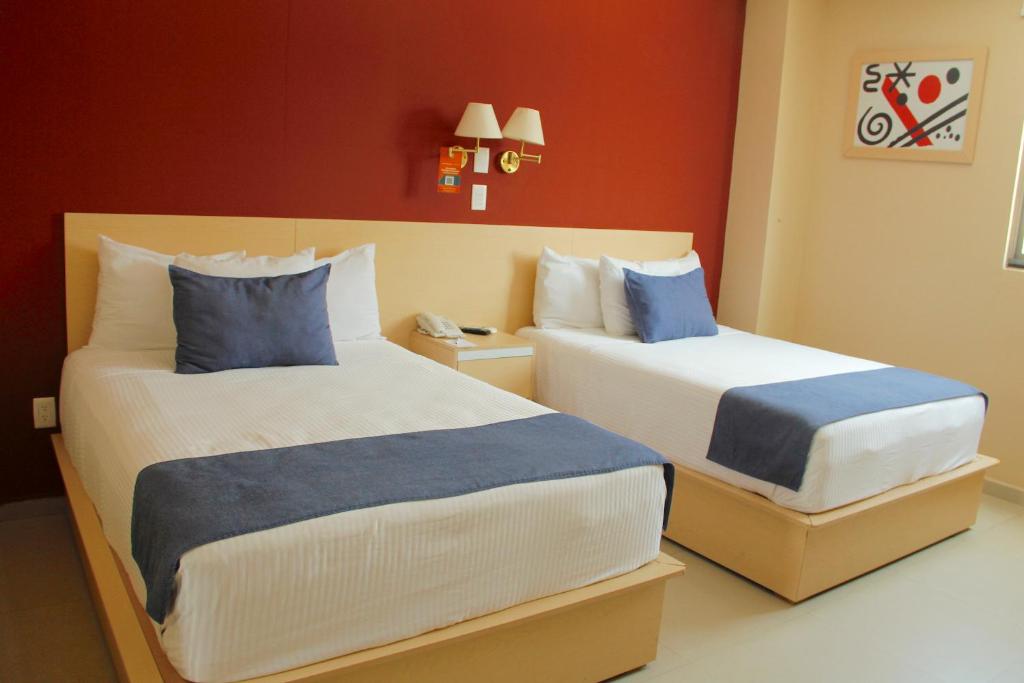 En eller flere senge i et værelse på Premier Inn Tuxtla