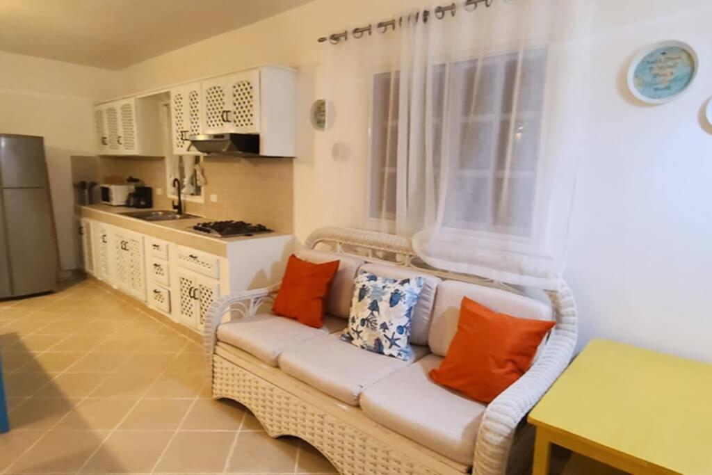 a living room with a white couch with pillows on it at Playa Turquesa only 50m From the Beach Walk to all Restaurants in Las Terrenas